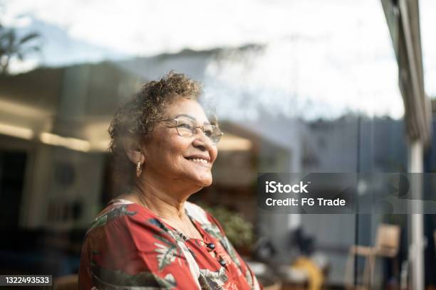 Senior Woman Contemplating At Home Stock Photo - Download Image Now - Senior Adult, Happiness, One Woman Only