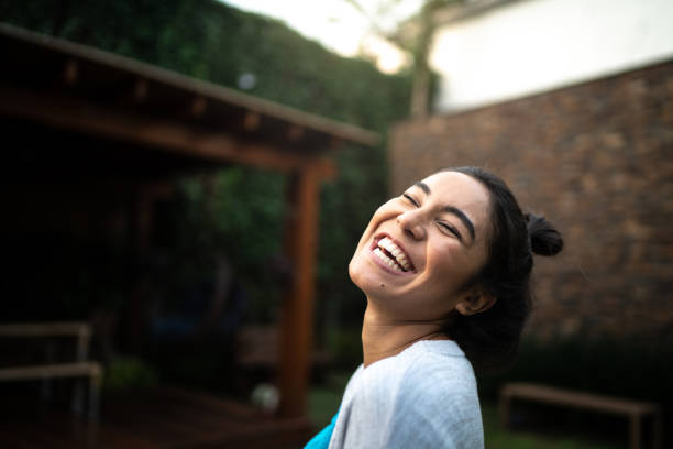 istock Happy woman laughing at home 1322494088