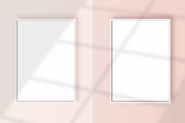 istock Image of a two vertical white frame mockup on a light pink wall blank mockup template. 1322494100