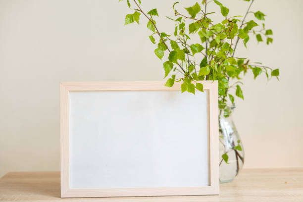 istock Portrait white picture frame mockup on wooden table 1322494673