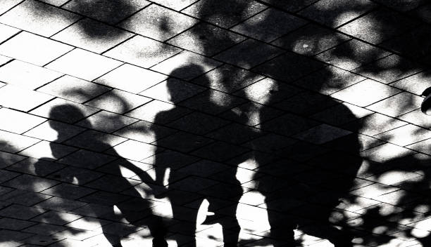 istock Blurry shadow silhouette of  people walking 1322494678