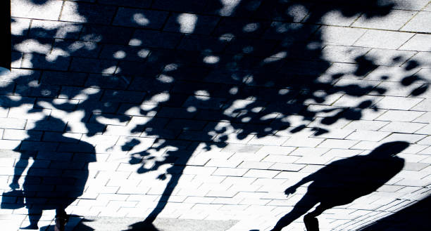 istock Blurry shadow silhouette of two people standing alone under a tree 1322494703