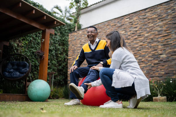 istock Senior man doing physical therapy with doctor at home 1322494752