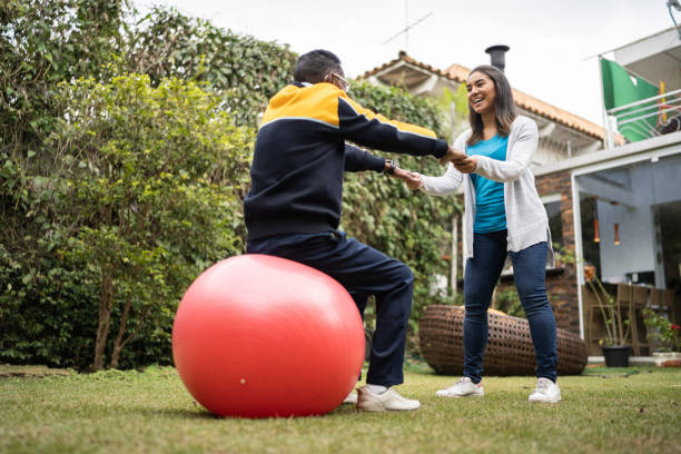 istock Senior man doing exercise with physical therapist at home 1322494777
