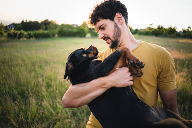 istock Man holding a puppy dog 1322495958