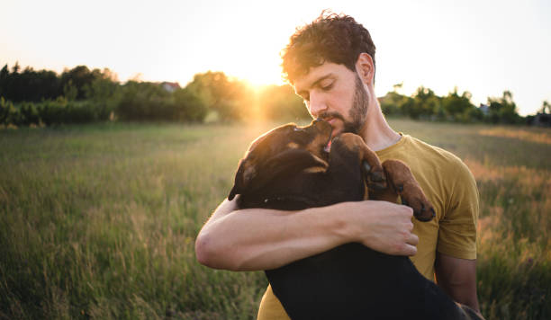istock Man holding a puppy dog 1322495966
