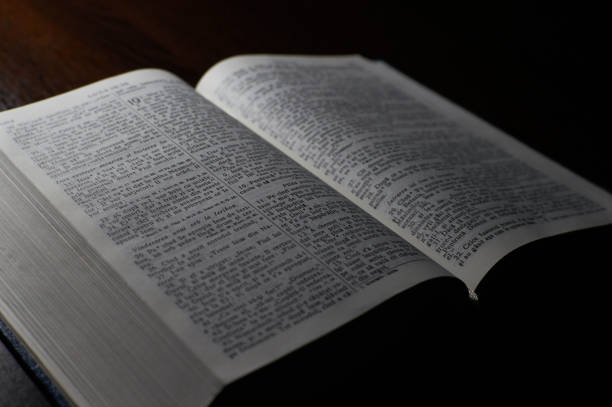 istock Open christian Bible on a wooden Slate Table 1322496803