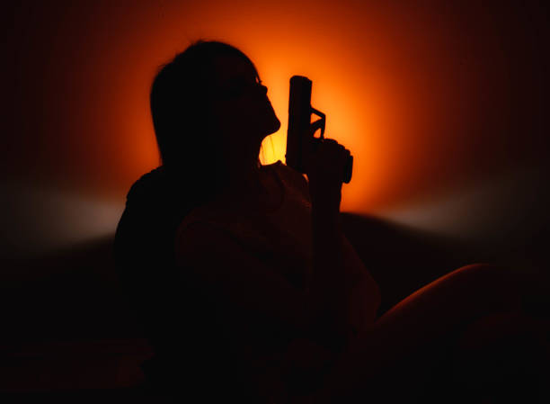 Womans silhouette in different colors, sitting, standing and dancing, holding a gun, poster, HD stock photography.