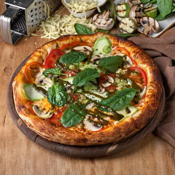 Photo of Large vegeterian pizza with sauces and pepper
