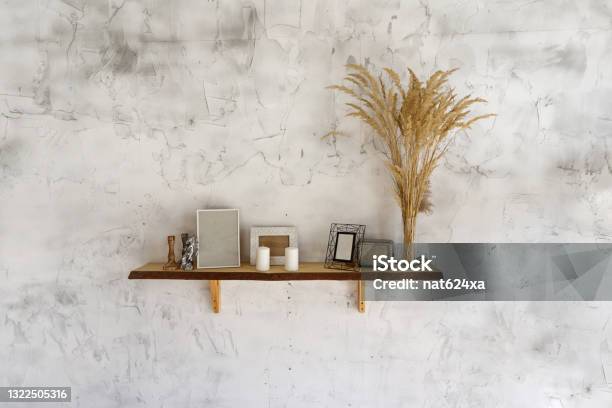 White Eco Style Wall With A Shelf And Pampas Grass Candles And Photo Frames Decoration Stock Photo - Download Image Now