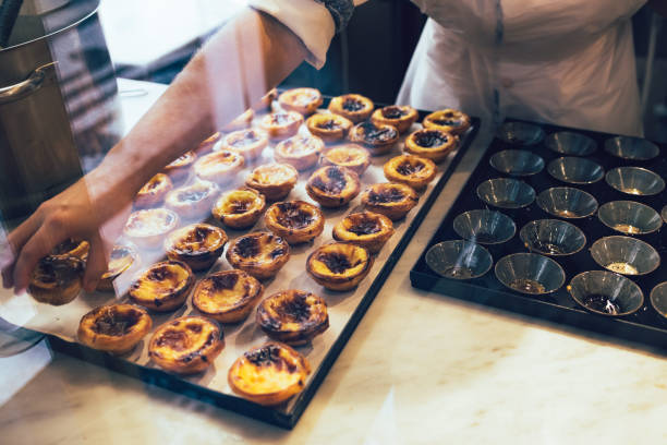 Portuguese dessert - Pastel de nata. Traditional Portuguese dessert - Pastel de nata in baking processes. pasteis de belem stock pictures, royalty-free photos & images