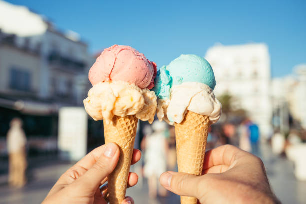 istock Hands holding ice cream in waffle cones. 1322506595