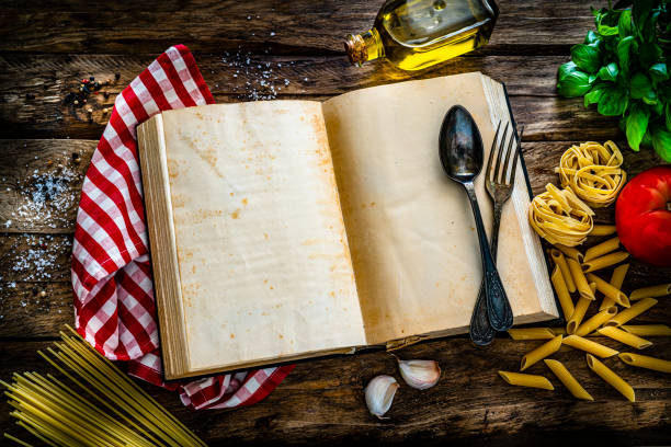 istock Pasta recipe book with blank pages on rustic table 1322508569