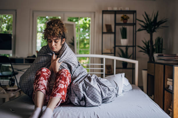 istock Sick sitting woman in bed 1322508574