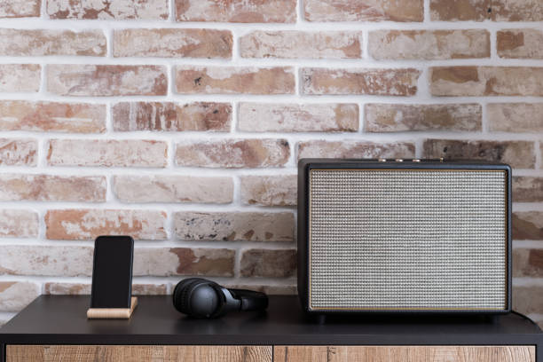 istock Bluetooth column speaker, headphones and smartphone on table 1322511796