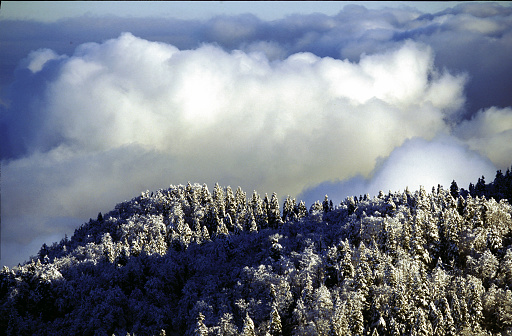 Clouds with fresh snow on the Bijele stijene mountains in Croatia
