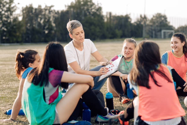 istock Coach and her team making a play strategy before a game 1322512752