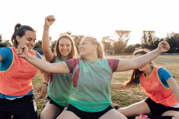 girls in a rugby team cheering for the score - youth organization imagens e fotografias de stock