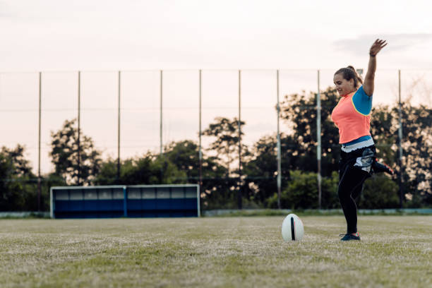 istock Girl practicing a ball kick on a rugby field 1322512770