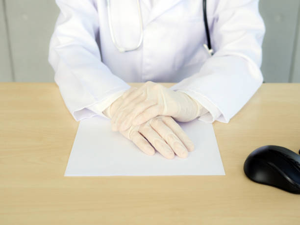 A piece of top-secret information is under the female doctor's hands. stock photo