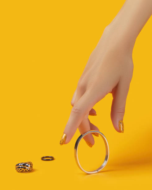 istock Womans hand with jewelry accessories over orange background 1322515878