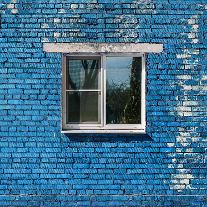 Blue brick wall and window. Brick building. Old brickwork.