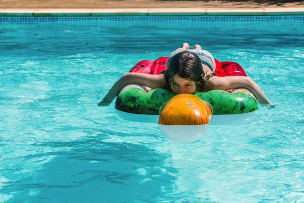 istock cute young girl basking on her floating mattress 1322519205
