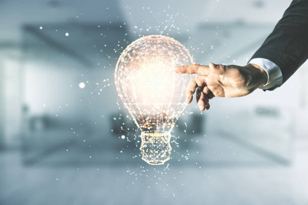 istock Man hand presses on virtual Idea concept with light bulb illustration on blurred office background. Multiexposure 1322520623