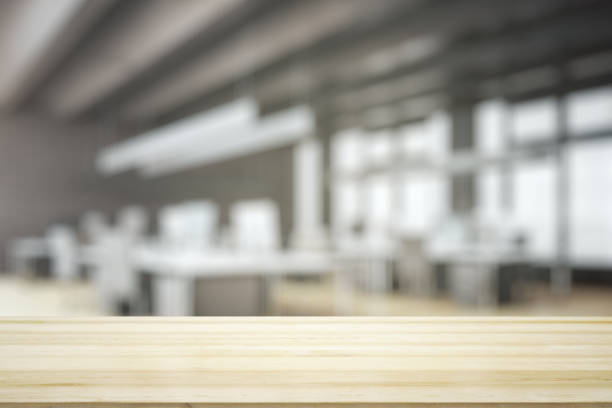 istock Empty wooden tabletop with modern furnished office on background, mock up 1322520784
