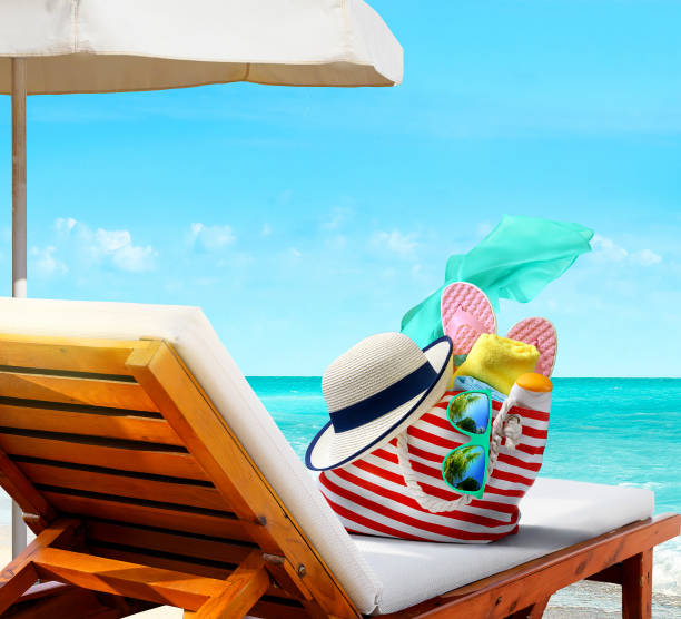istock Beach bag with accessories on sun lounger on the beach 1322520938