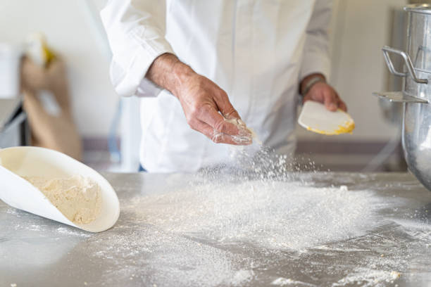 close-up of bakery chef hands preparing dough stock photo
