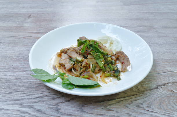 istock spicy roasted pork Thai salad eat with fresh basil leaf and cabbage 1322523226