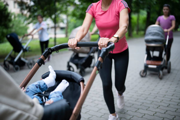 istock Young mothers training in public park with their babies. 1322525867