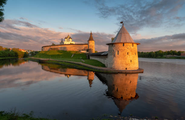 Pskov Kremlin, Russia, at sunset, illuminated by the rays of the sun. Pskov Kremlin, Russia, at sunset, illuminated by the rays of the sun, at the confluence of two rivers, the Great and Pskov. pskov city stock pictures, royalty-free photos & images