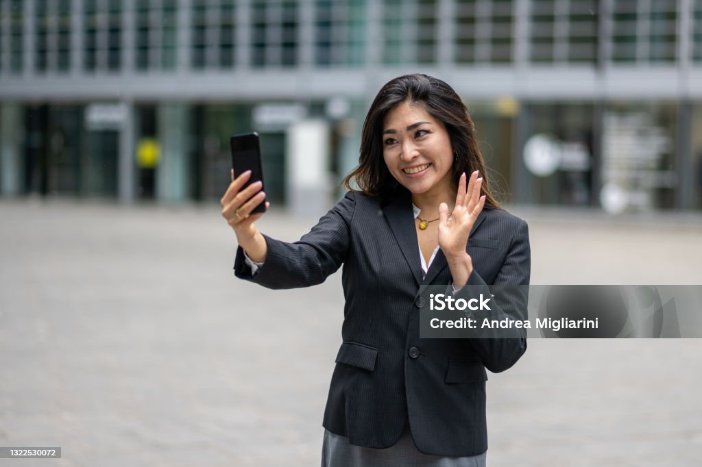 confident business woman having a video call, young and attractive japanese woman using smartphone for communicate, concept of women’s success and career in business 30-39 Years Stock Photo