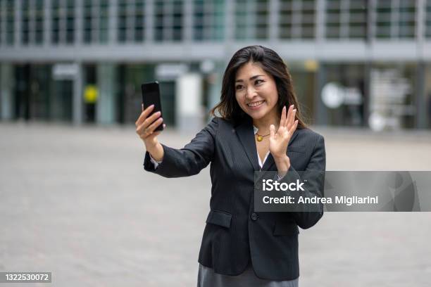 Confident Business Woman Having A Video Call Young And Attractive Japanese Woman Using Smartphone For Communicate Concept Of Womens Success And Career In Business Stock Photo - Download Image Now
