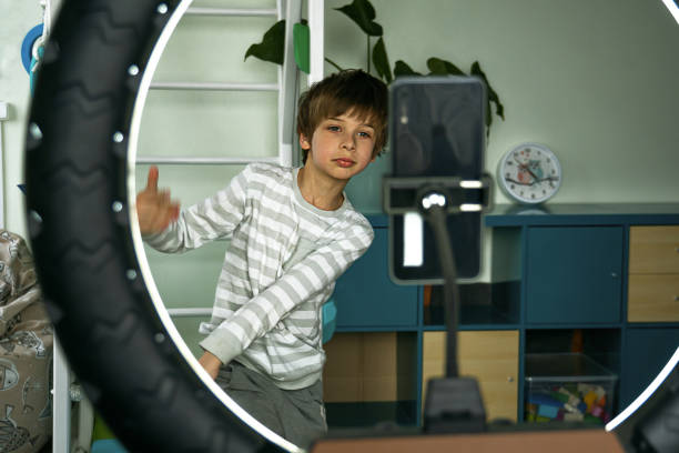 istock A boy films his dance on his phone for social media. 1322530421