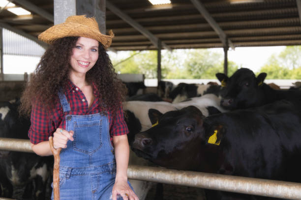 istock Farm worker in the cow shed 1322530673