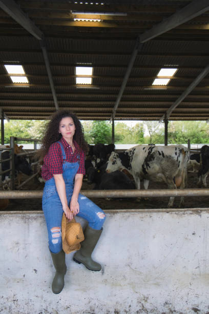 istock Farm worker in the cow shed 1322530855