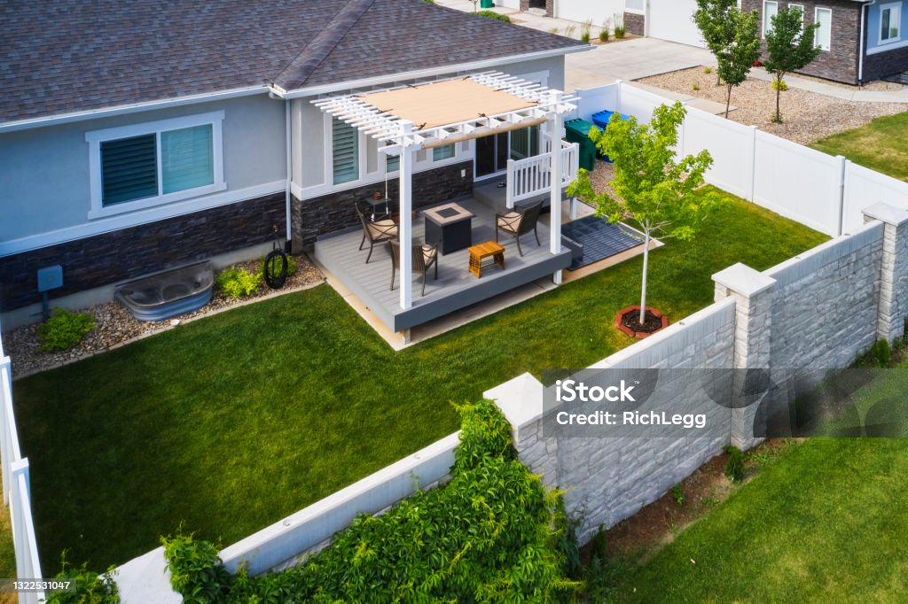 Backyard Deck and Pergola A backyard of a suburban USA home with a deck and pergola, aerial view. Back Yard Stock Photo