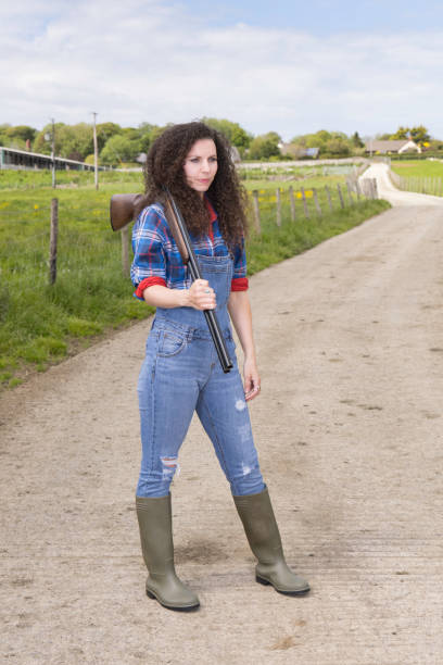 istock Lady on a farm with her shotgun 1322531081
