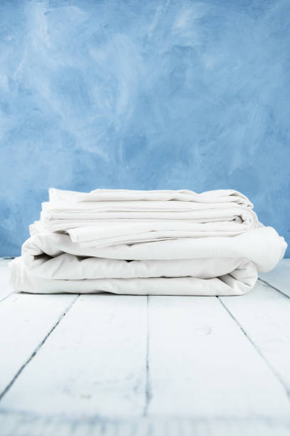 istock New clean folded bed linens on wooden table indoors 1322531098