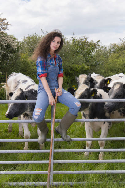 istock Lady sitting on a farm gate 1322531658