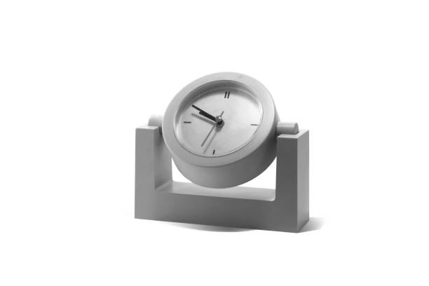 Black and white image of old classic round table clock isolated on white background as symbol of eternity with clock, symbol of time with clock or symbol of transience of time on clock