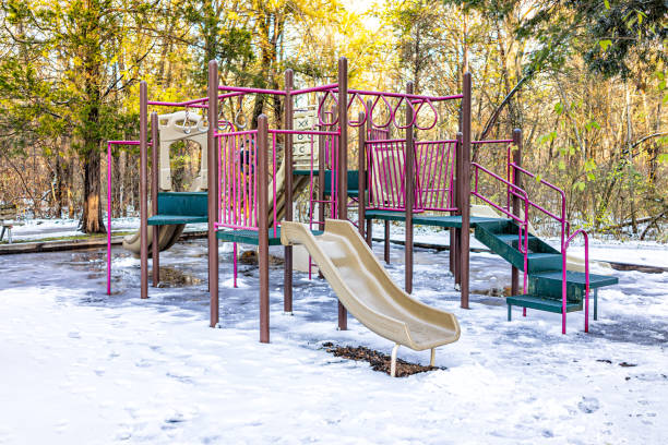 Herndon, Northern Virginia in Fairfax county residential neighborhood with children's playground covered in snow winter weather with nobody and sunlight in Sugarland Run Herndon, Northern Virginia in Fairfax county residential neighborhood with children's playground covered in snow winter weather with nobody and sunlight in Sugarland Run herndon virginia stock pictures, royalty-free photos & images