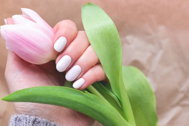 istock Female hand with beautiful manicure with tulip 1322537421