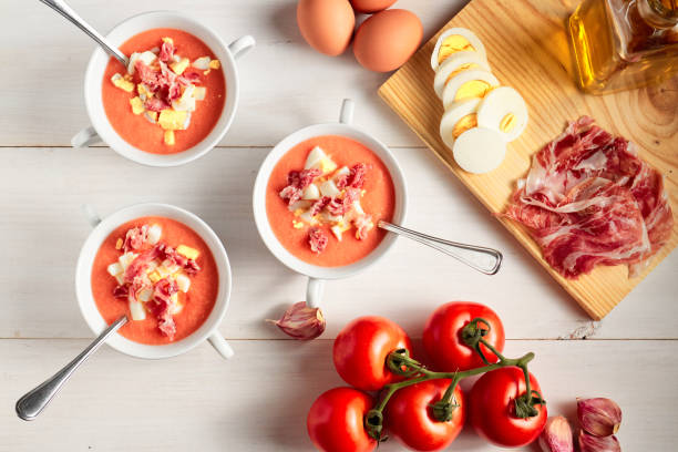 Tomato soup, salmorejo, with raw ingredients on a table, copy space, typical spanish food stock photo
