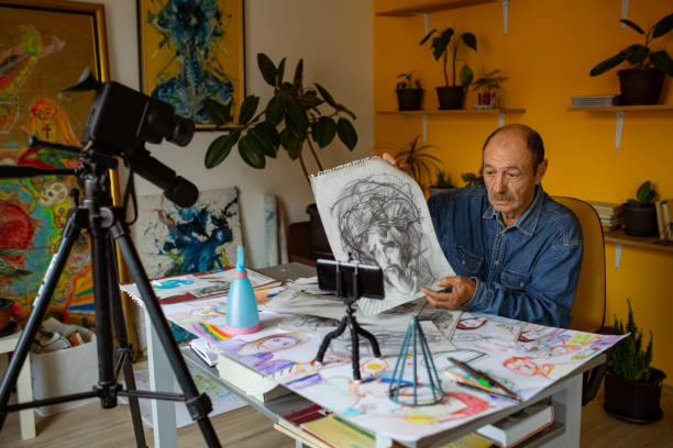 istock Senior artist working on drawing at home 1322539688