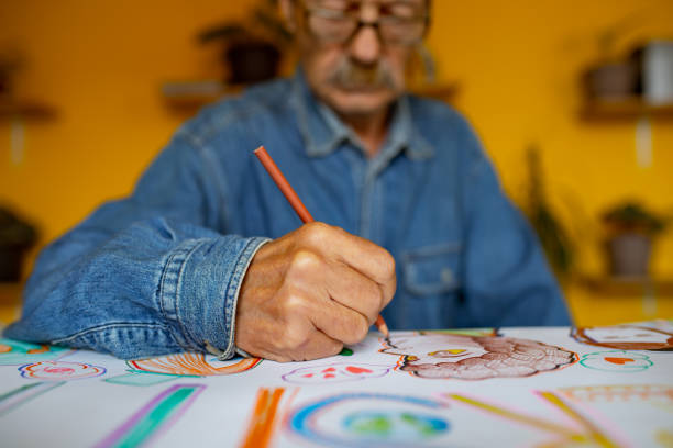 Close-up of an senior artist as drawn on paper