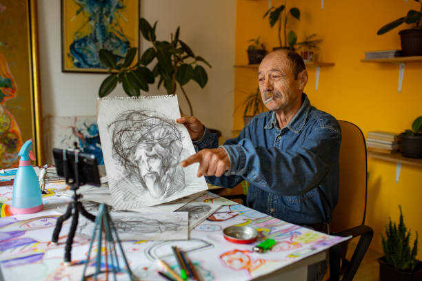 istock Senior artist working on drawing at home 1322539713